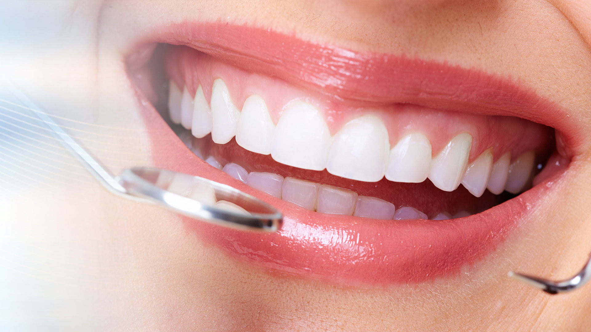 The image shows a person with a bright smile, displaying perfect teeth and holding an oral hygiene device, suggesting dental care or promotion.