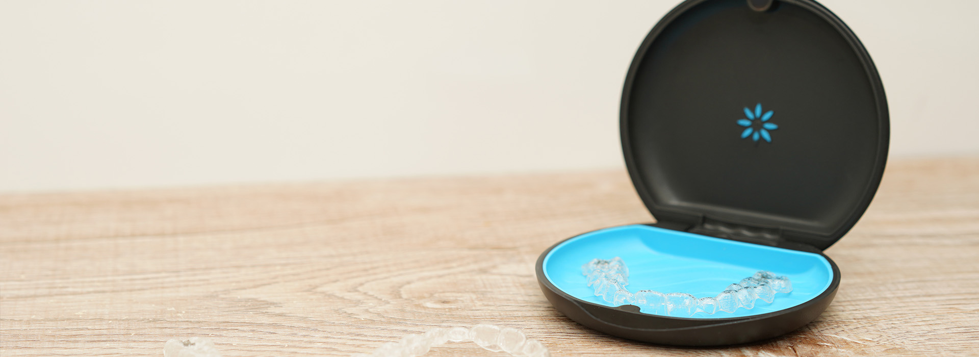 An image of a small, blue smart home device with a black base resting on a light-colored surface.